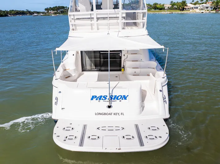  Yacht Photos Pics 2003 Sea Ray 560 Sedan Bridge yacht on water, rear view, named "Passion," Longboat Key, FL.