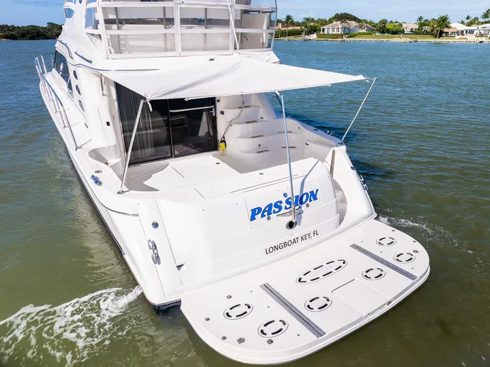  Yacht Photos Pics 2003 Sea Ray 560 Sedan Bridge yacht on water, rear view with canopy.