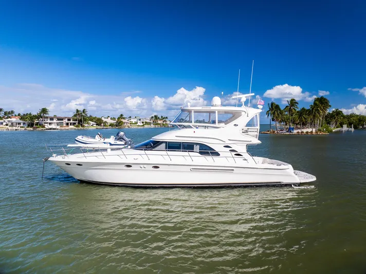  Yacht Photos Pics 2003 Sea Ray 560 Sedan Bridge yacht cruising on a sunny day.