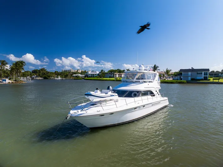  Yacht Photos Pics 2003 Sea Ray 560 Sedan Bridge yacht cruising on a sunny day.
