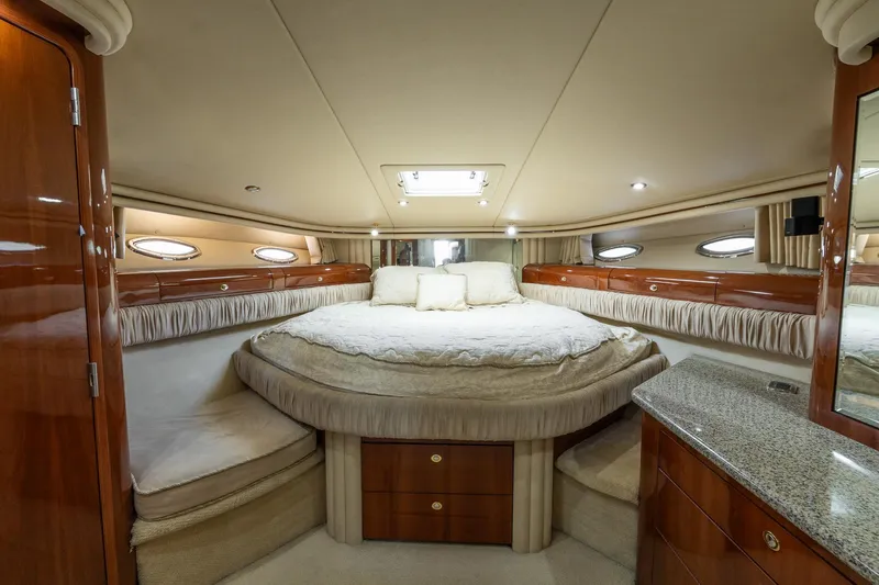  Yacht Photos Pics Luxurious 2003 Sea Ray 560 Sedan Bridge yacht bedroom with elegant wood finishes.