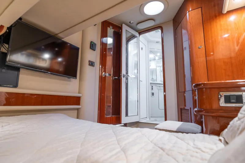  Yacht Photos Pics Luxurious cabin interior of 2003 Sea Ray 560 Sedan Bridge yacht with TV and ensuite bathroom.