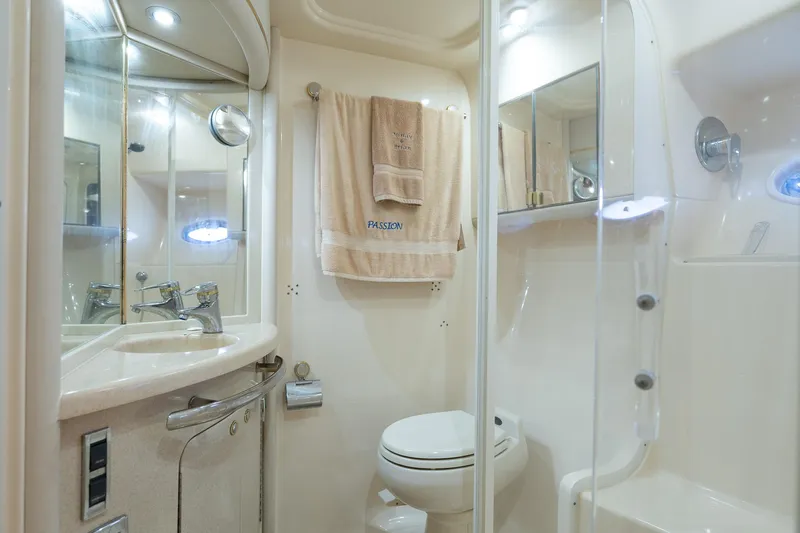  Yacht Photos Pics Luxurious bathroom in 2003 Sea Ray 560 Sedan Bridge yacht, featuring modern fixtures and elegant design.