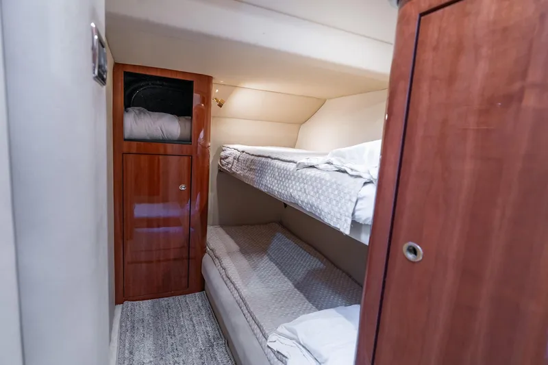  Yacht Photos Pics 2003 Sea Ray 560 Sedan Bridge cabin with bunk beds and wooden storage.