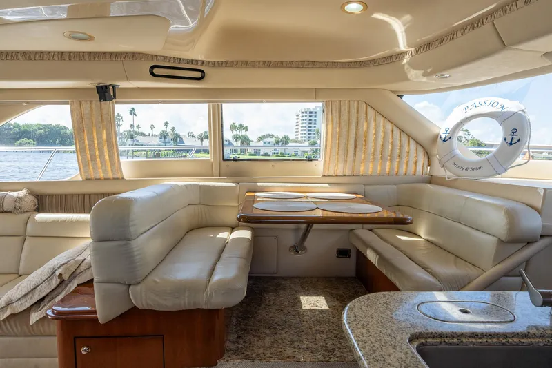  Yacht Photos Pics Luxurious interior of 2003 Sea Ray 560 Sedan Bridge yacht with elegant seating and dining area.