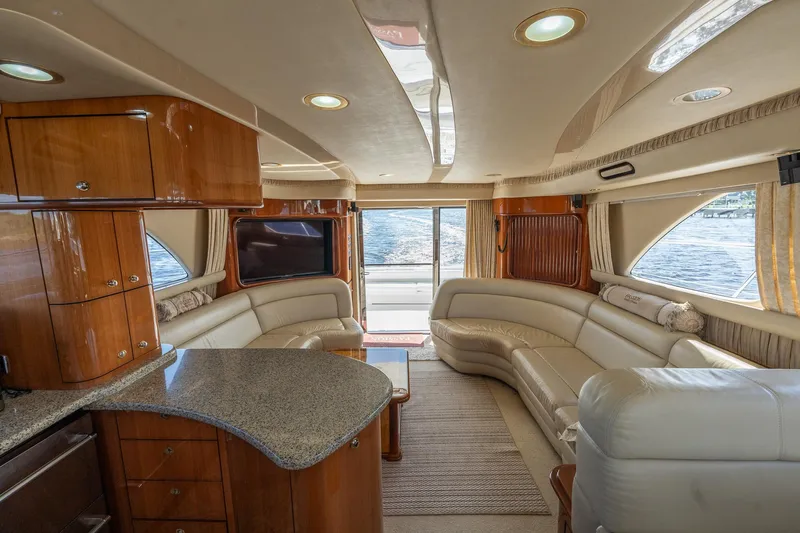  Yacht Photos Pics Luxurious interior of 2003 Sea Ray 560 Sedan Bridge yacht with elegant seating and wood finishes.
