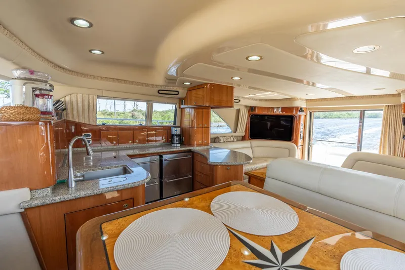  Yacht Photos Pics Luxurious 2003 Sea Ray 560 Sedan Bridge yacht interior with modern kitchen and dining area.