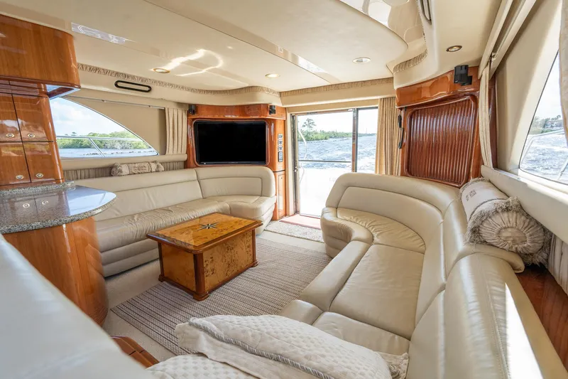 Yacht Photos Pics Luxurious interior of 2003 Sea Ray 560 Sedan Bridge yacht with leather seating and large windows.