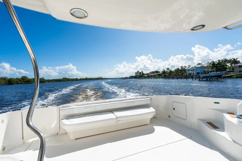 Yacht Photos Pics 2003 Sea Ray 560 Sedan Bridge cruising on a sunny day, scenic waterfront view.