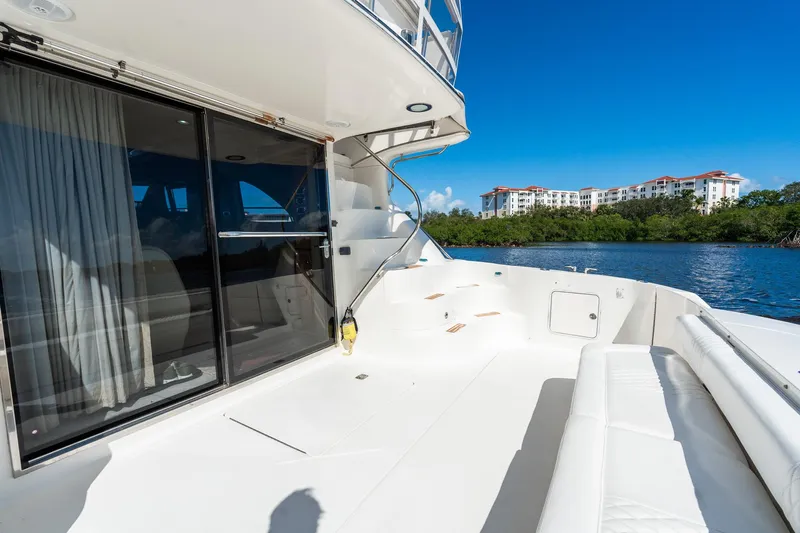  Yacht Photos Pics 2003 Sea Ray 560 Sedan Bridge yacht deck with scenic waterfront view.