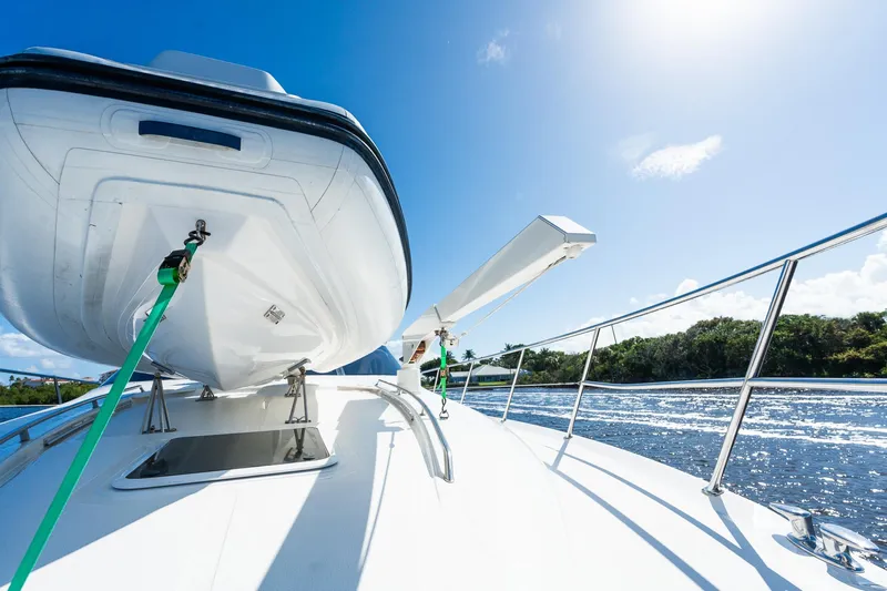  Yacht Photos Pics 2003 Sea Ray 560 Sedan Bridge yacht on water, sunny day, clear blue sky.