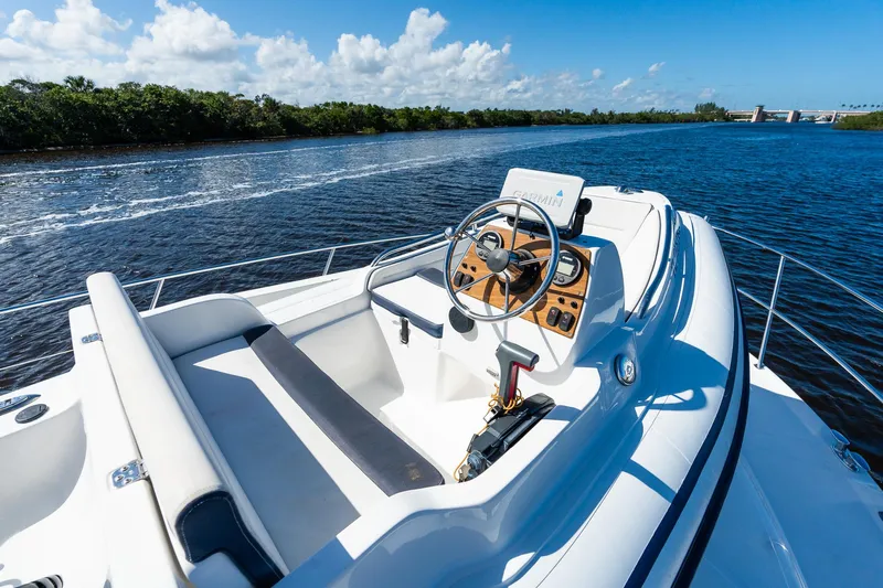  Yacht Photos Pics 2003 Sea Ray 560 Sedan Bridge yacht on a sunny day, cruising through calm waters.