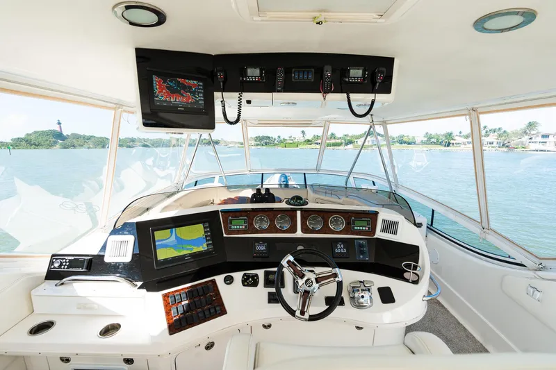  Yacht Photos Pics 2003 Sea Ray 560 Sedan Bridge helm with navigation equipment and panoramic water view.