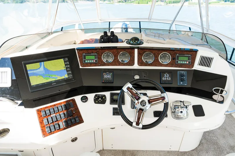  Yacht Photos Pics Cockpit of 2003 Sea Ray 560 Sedan Bridge with navigation equipment and steering wheel.
