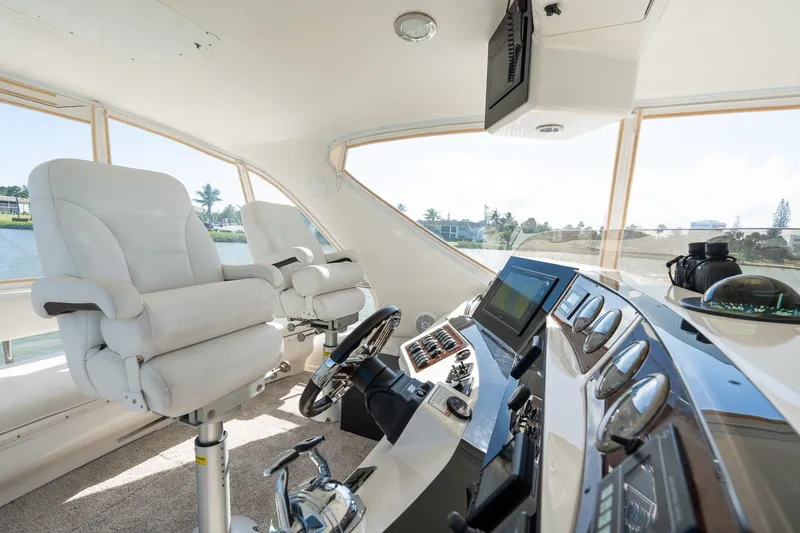  Yacht Photos Pics Luxurious 2003 Sea Ray 560 Sedan Bridge helm with modern controls and plush seating.