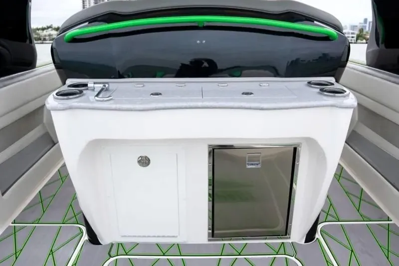  Yacht Photos Pics 2024 Deep Impact 399 Sport boat interior with sleek countertop and built-in mini fridge.