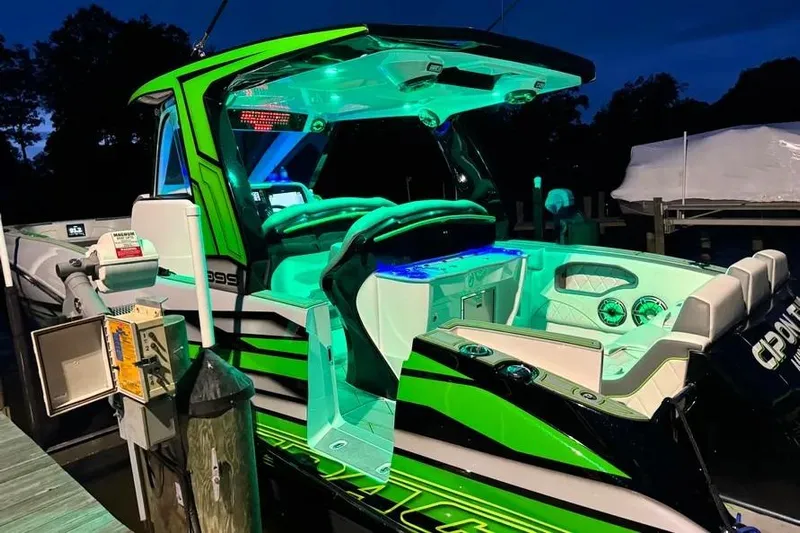  Yacht Photos Pics 2024 Deep Impact 399 Sport boat with vibrant green and blue LED lighting at night.