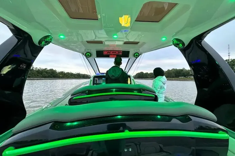  Yacht Photos Pics 2024 Deep Impact 399 Sport boat interior with green LED lighting on the water.