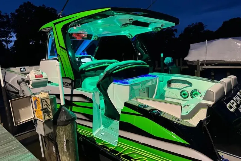  Yacht Photos Pics 2024 Deep Impact 399 Sport boat with vibrant green and blue LED lighting at night.
