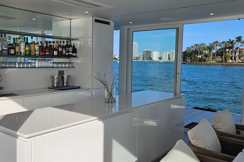 The Myth Yacht Photos Pics Luxurious ARKHAUS Villa 50 interior with modern bar, overlooking scenic waterfront view, 2025 model.