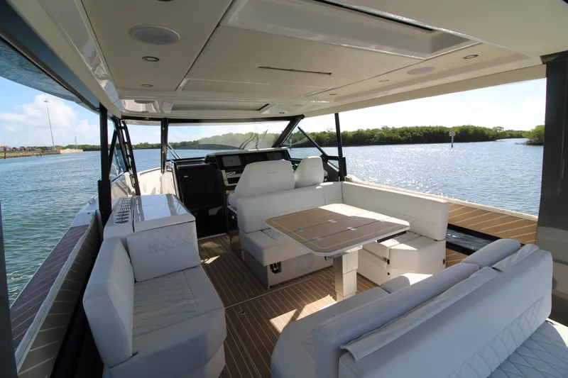  Yacht Photos Pics 2025 Saxdor 400 GTS luxury boat interior with seating and table on a sunny day.