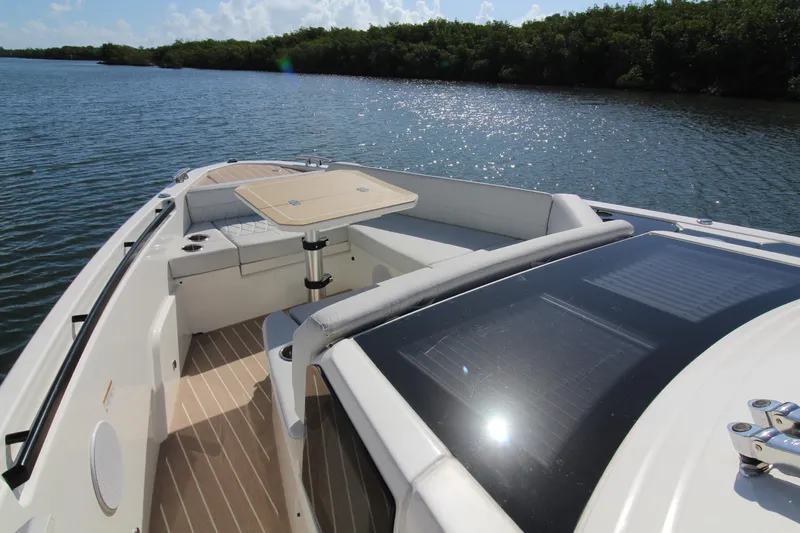  Yacht Photos Pics 2025 Saxdor 400 GTS boat with seating and table on a sunny lake.