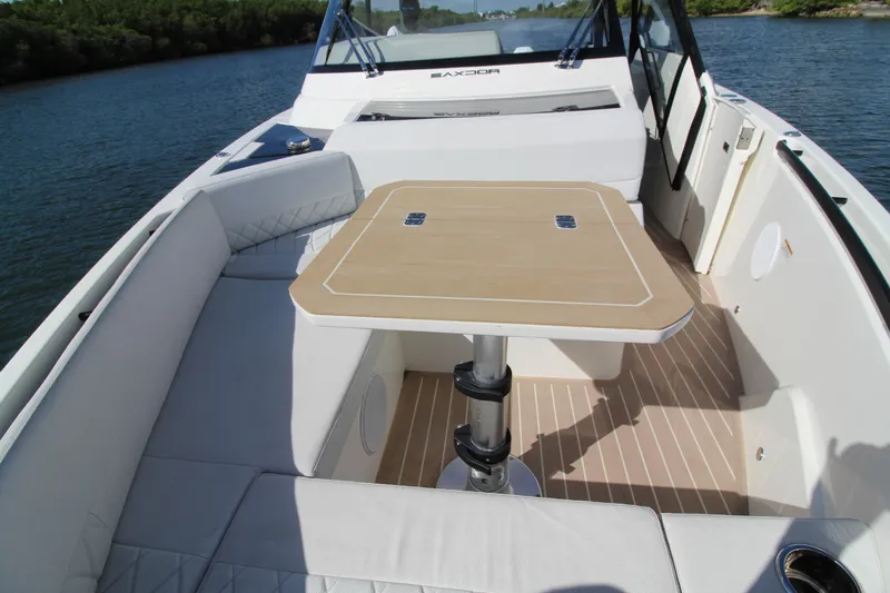  Yacht Photos Pics 2025 Saxdor 400 GTS boat interior with seating and table on calm water.