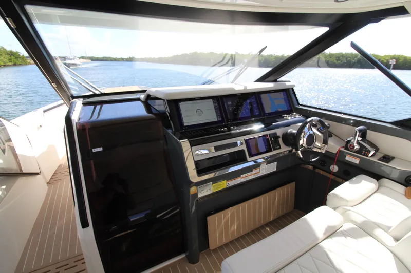  Yacht Photos Pics Helm of 2025 Saxdor 400 GTS yacht with modern navigation equipment and luxurious seating.