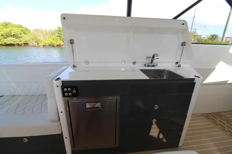  Yacht Photos Pics 2025 Saxdor 400 GTS yacht kitchenette with sink and storage, overlooking water.