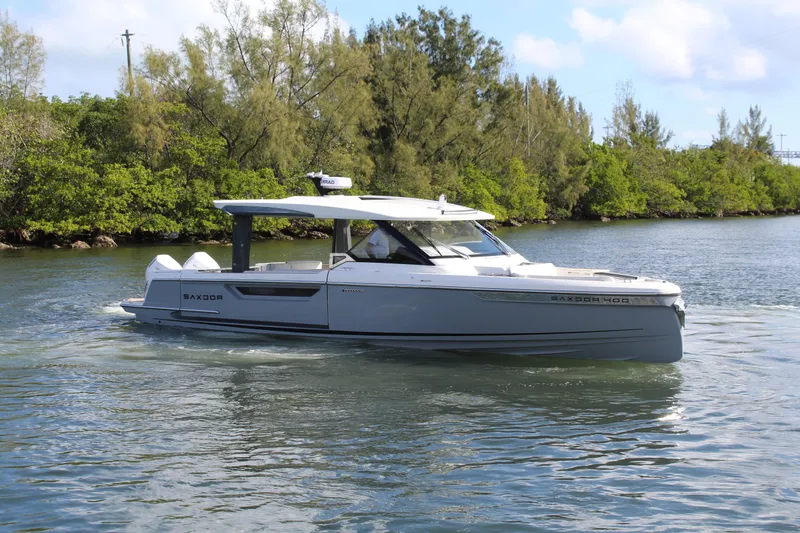  Yacht Photos Pics 2025 Saxdor 400 GTS luxury boat cruising on a serene waterway.