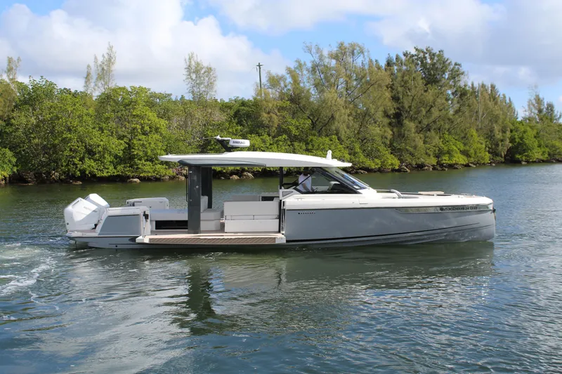  Yacht Photos Pics 2025 Saxdor 400 GTS boat cruising on a serene waterway with lush greenery.