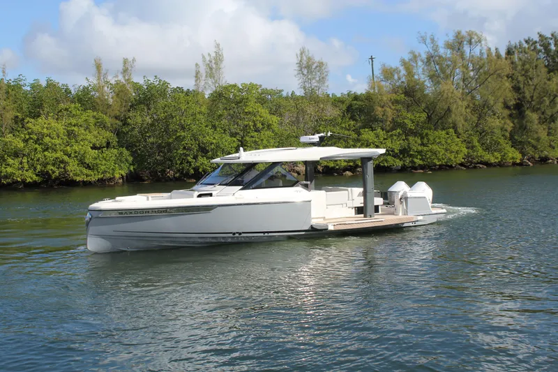  Yacht Photos Pics 2025 Saxdor 400 GTS cruising on a serene river, surrounded by lush greenery.