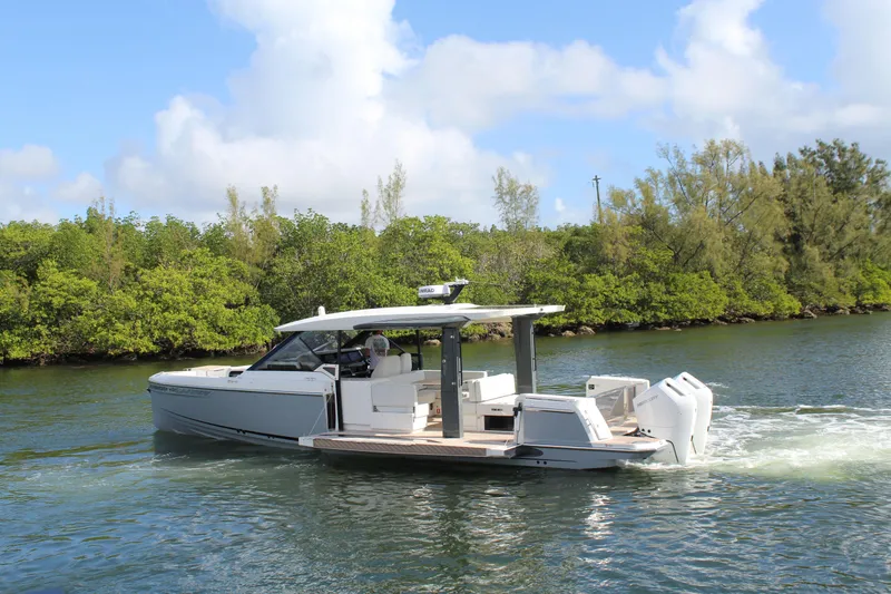  Yacht Photos Pics 2025 Saxdor 400 GTS cruising on a scenic river with lush greenery.