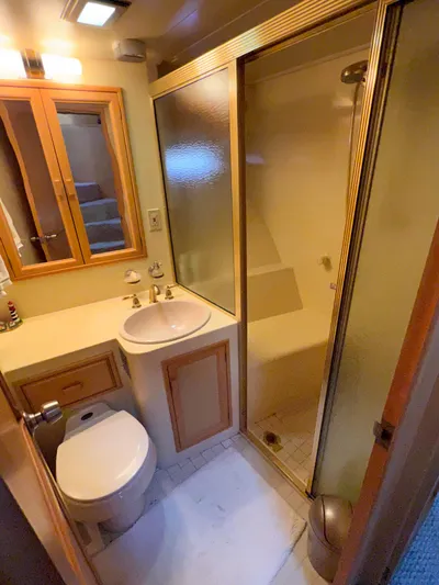 Audacious Yacht Photos Pics Compact bathroom in 1986 Southern Cross 53 yacht with shower, sink, and toilet.
