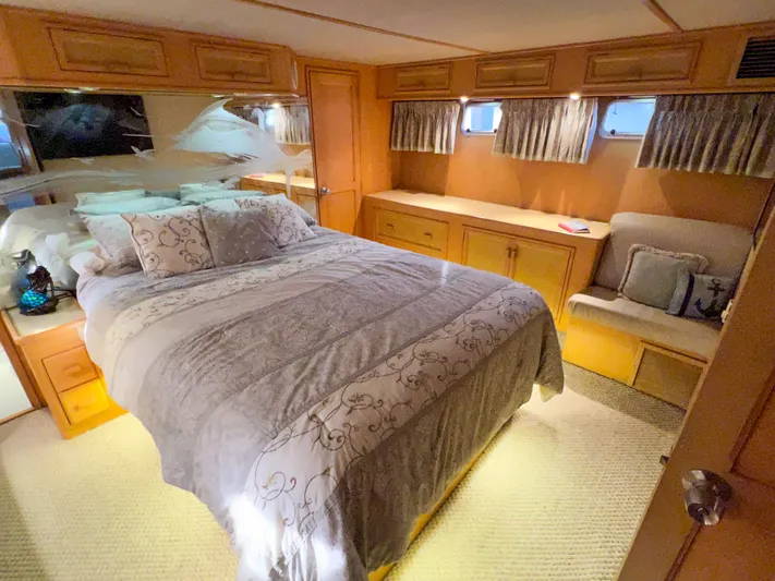 Audacious Yacht Photos Pics Luxurious bedroom interior of 1986 Southern Cross 53 yacht with elegant bedding and wood accents.