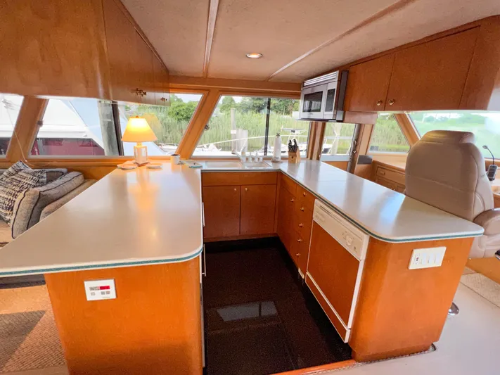 Audacious Yacht Photos Pics Interior of 1986 Southern Cross 53 yacht with modern kitchen and panoramic windows.