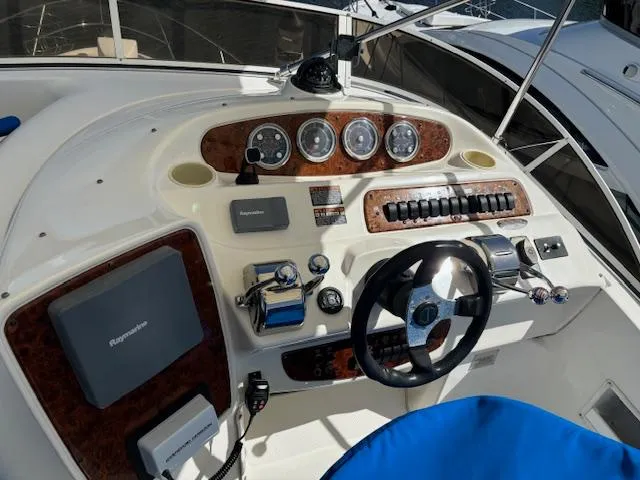  Yacht Photos Pics 2004 Meridian Sedan Bridge 341 helm with gauges, controls, and steering wheel.