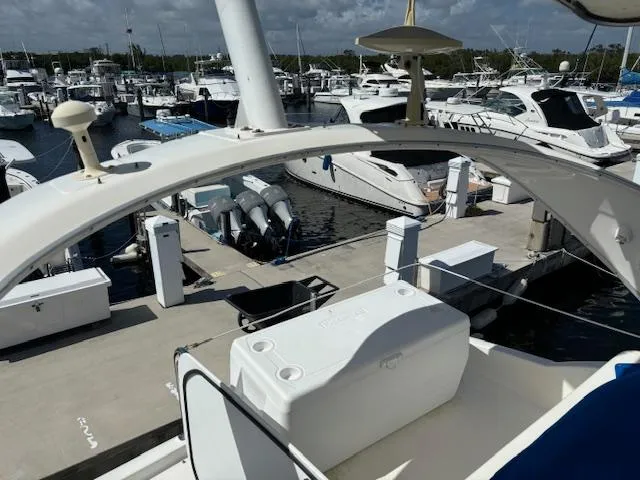  Yacht Photos Pics 2004 Meridian Sedan Bridge 341 at marina, surrounded by boats and docks.