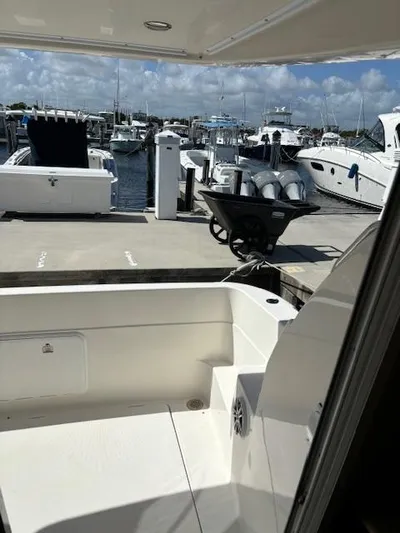  Yacht Photos Pics 2004 Meridian Sedan Bridge 341 at marina, docked with other boats under a cloudy sky.