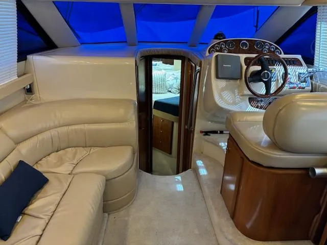  Yacht Photos Pics Interior of 2004 Meridian Sedan Bridge 341 with beige seating and wooden accents.