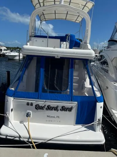  Yacht Photos Pics 2004 Meridian Sedan Bridge 341 docked in Miami, FL, with blue canopy.