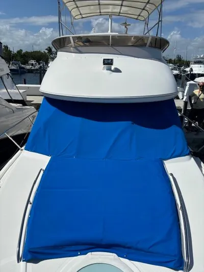  Yacht Photos Pics 2004 Meridian Sedan Bridge 341 with blue cover, docked at marina.