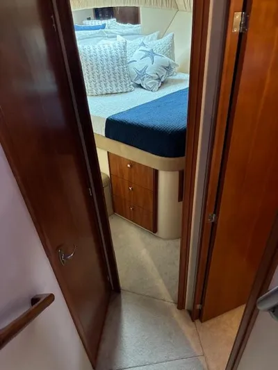  Yacht Photos Pics Cozy bedroom in 2004 Meridian Sedan Bridge 341 yacht with nautical-themed decor.