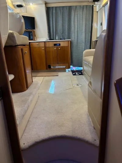  Yacht Photos Pics Interior of 2004 Meridian Sedan Bridge 341 yacht, featuring cozy seating and wooden cabinetry.