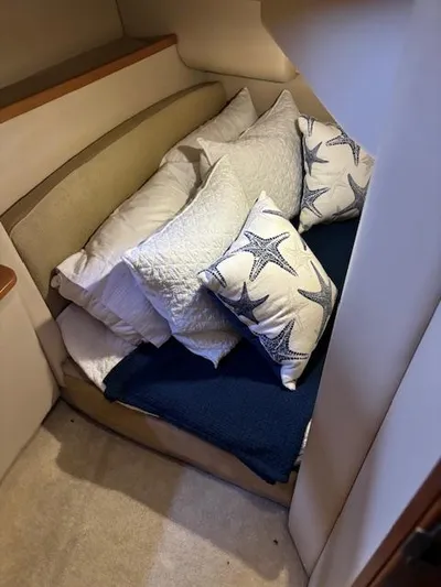  Yacht Photos Pics Cozy cabin interior of 2004 Meridian Sedan Bridge 341 with starfish-themed pillows.