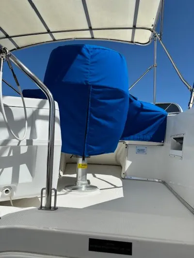  Yacht Photos Pics 2004 Meridian Sedan Bridge 341 boat with blue seat covers and canopy.