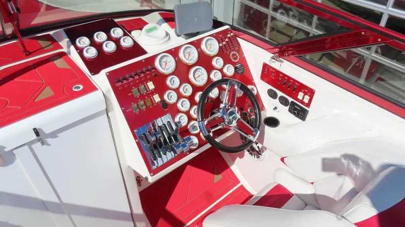  Yacht Photos Pics 2002 Fountain 47 Lightning boat dashboard with red and white design, featuring multiple gauges and controls.