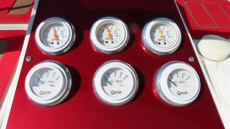  Yacht Photos Pics Dashboard gauges of a 2002 Fountain 47 Lightning boat, featuring fuel and pressure indicators.