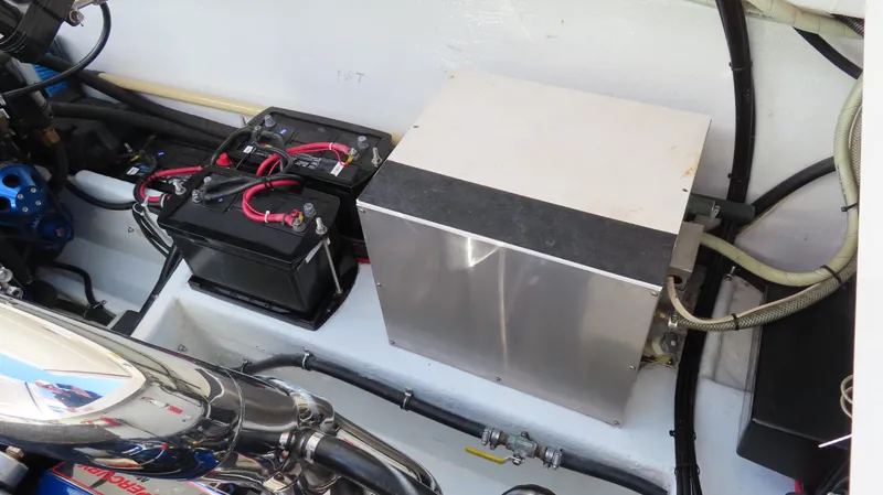  Yacht Photos Pics Engine compartment of a 2002 Fountain 47 Lightning boat, featuring batteries and wiring.