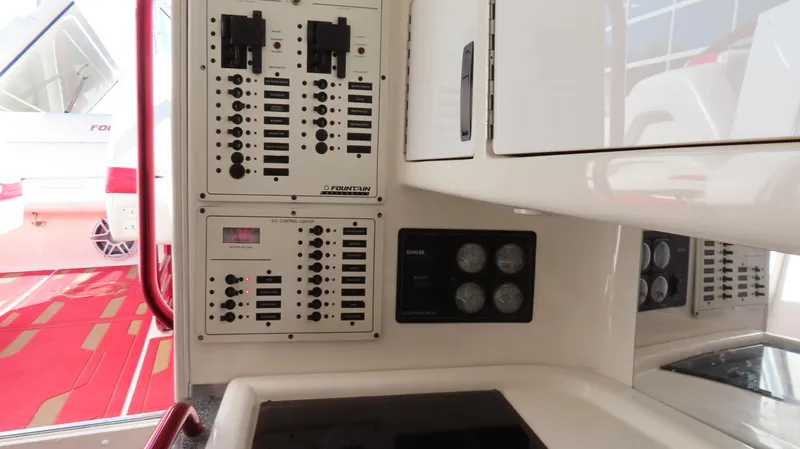  Yacht Photos Pics Control panel of a 2002 Fountain 47 Lightning boat, featuring switches and gauges.